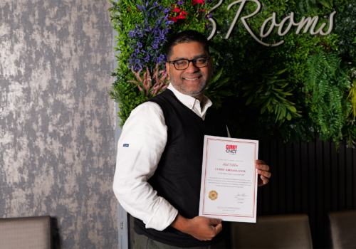 Jilal Uddin, owner of Three Rooms Indian Restaurant, holding his Curry CNCT certificate appointing him Curry Ambassador for the South East for 2026–2027.