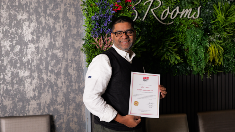Jilal Uddin, owner of Three Rooms Indian Restaurant, holding his Curry CNCT certificate appointing him Curry Ambassador for the South East for 2026–2027.